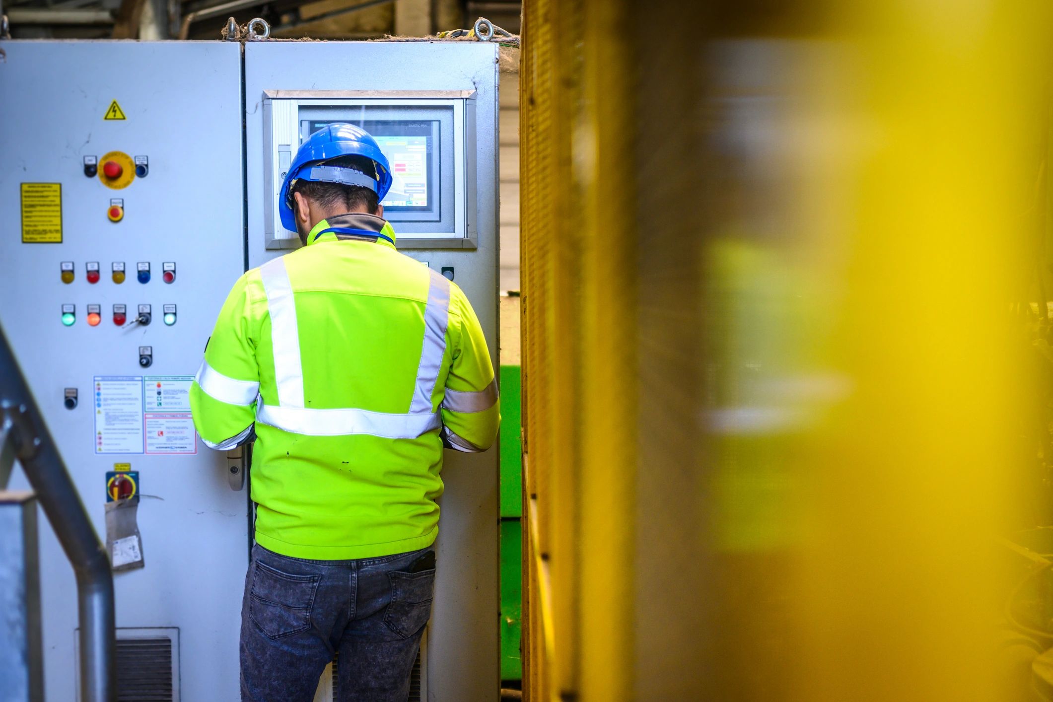 Technician monitoring industrial control systems